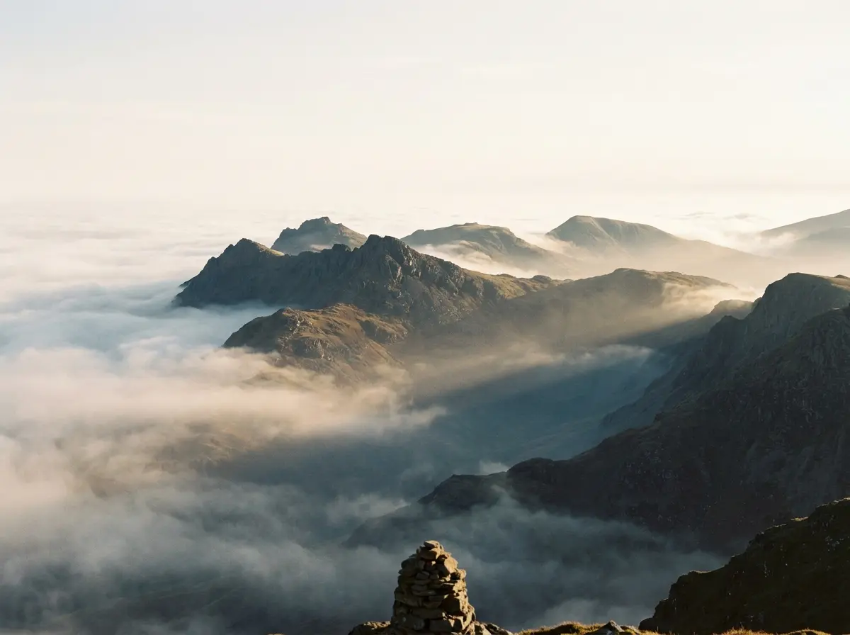Mountain peaks rising above morning mist at dawn